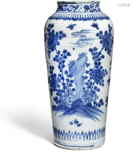 A Chinese blue and white sleeve vase painted with rocks and ...