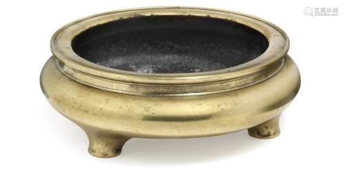 A Chinese bronze tripod censer with profiled rim
