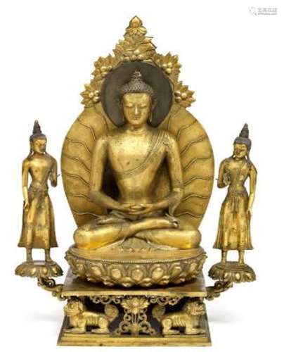A Chinese gilt bronze figure of Buddha flanked by Avalokites...