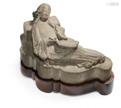 A Chinese carved limestone scroll weight of a reposing woman...