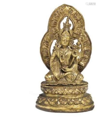 A Tibetan gilt copper repoussé figure of Padmasambhava