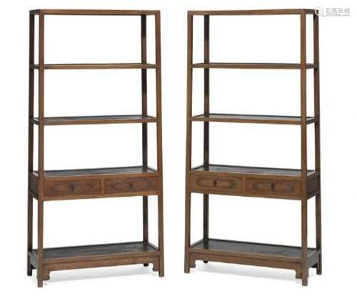 A pair of Chinese huanghuali showcases with open shelves and...