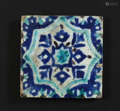 A Damascus pottery tile decorated in blue, turquoise and man...