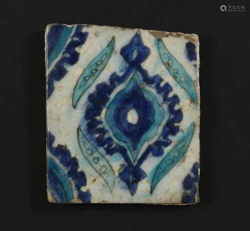 A Damascus pottery tile decorated in blue and turquoise with...