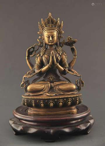 A BRONZE FOUR ARM GUAN YIN FIGURE