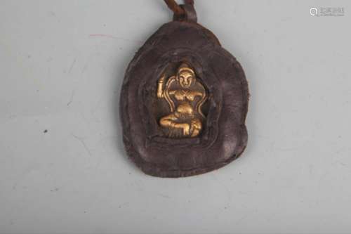 A COWHIDE WITH BRONZE TIBETAN BUDDHISM PENDANT