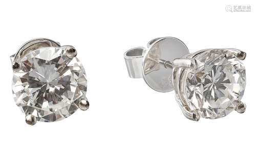 Pair of white gold ear studs with solitaire diamonds weighin...