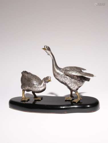 A JAPANESE SILVERED BRONZE OKIMONO OF TWO GEESE BY CHIKAYOSH...