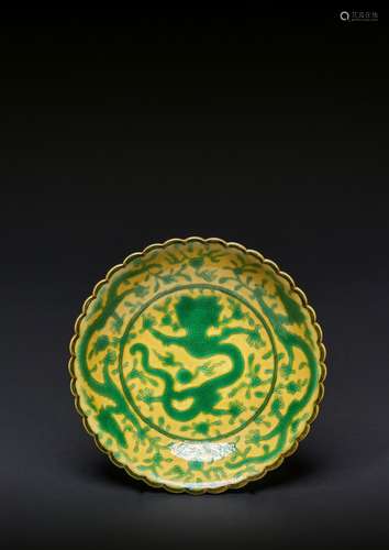 A CHINESE IMPERIAL GREEN-ENAMELLED YELLOW-GROUND DRAGON DISH...