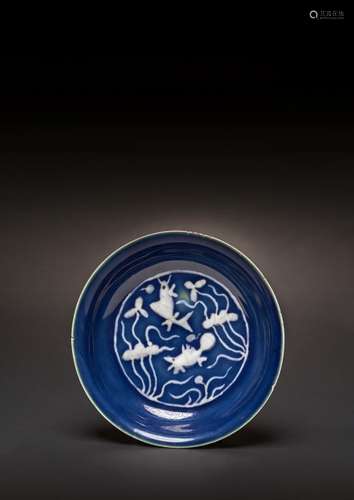 A RARE CHINESE REVERSE-DECORATED BLUE-GROUND DISH SIX CHARAC...