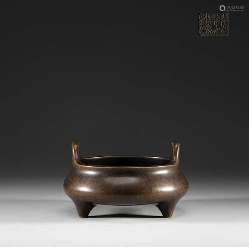 In the Ming Dynasty, a copper three legged double ear stove