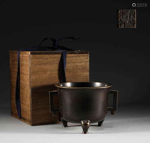 In the Qing Dynasty, copper three legged double ear stove