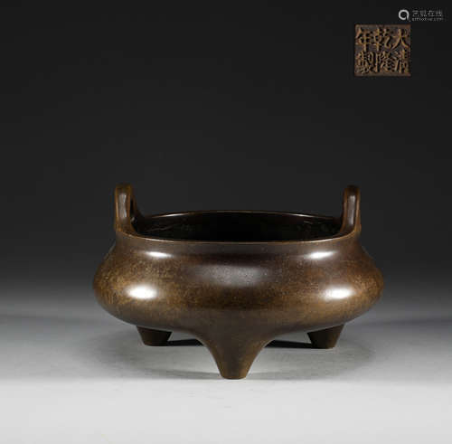 In the Qing Dynasty, copper three legged double ear stove