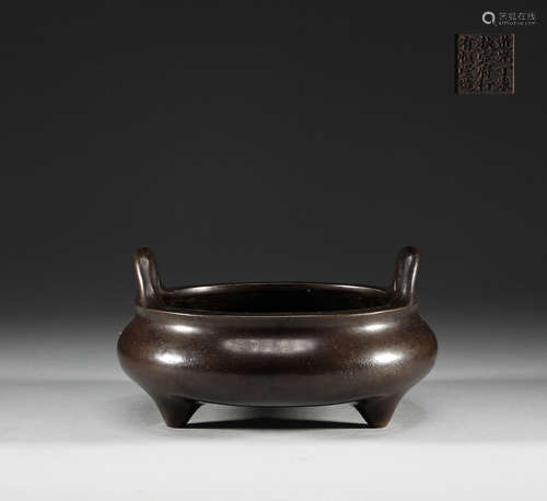 In the Qing Dynasty, copper three legged double ear stove