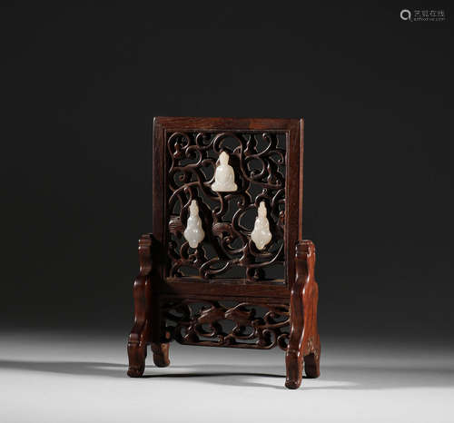 In the Qing Dynasty, yellow pear wood inlaid with white
 jad...