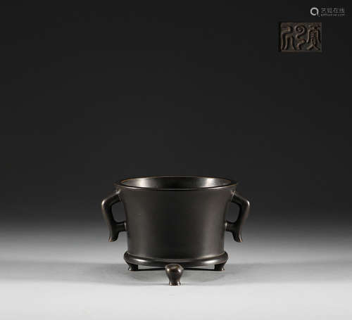 In the Qing Dynasty, copper three legged double ear stove