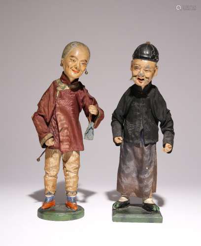 A PAIR OF CHINESE DOLLS 19TH CENTURY Standing on wooden base...