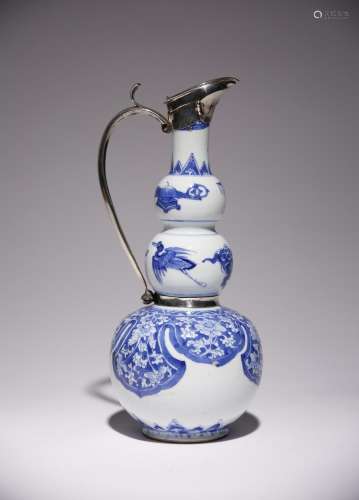 A CHINESE BLUE AND WHITE GOURD-SHAPED VASE MOUNTED AS A EWER...