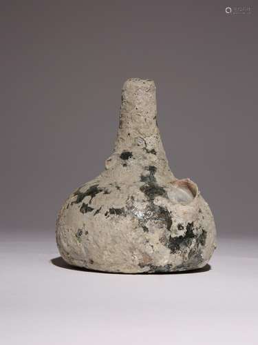 A GREEN GLASS WINE BOTTLE FROM THE NANKING CARGO MID 18TH CE...