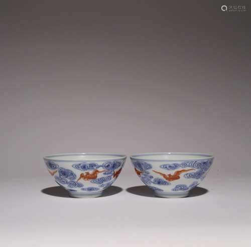 A PAIR OF CHINESE UNDERGLAZE BLUE AND IRON-RED BATS AND CLOU...