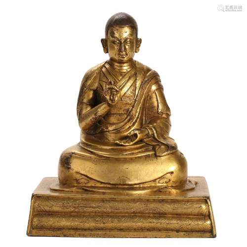 A GILT-BRONZE FIGURE OF A SEATED LAMA