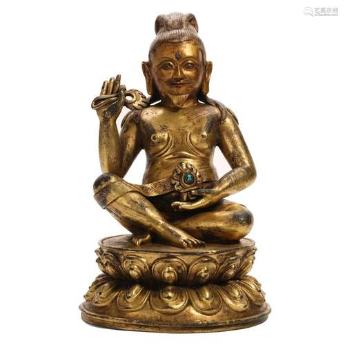 A GILT-BRONZE FIGURE OF A SEATED LAMA