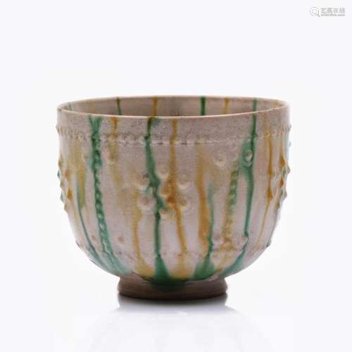 A CHINESE TANG STYLE RELIEFED CERAMIC CUP.