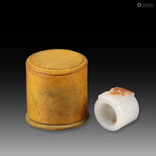 A CHINESE CARVED WHITE JADE RING WITH ORIGINAL SILK