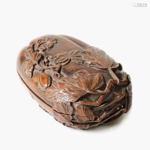 A CHINESE CARVED MELLON-SHAPED BAMBOO BOX.