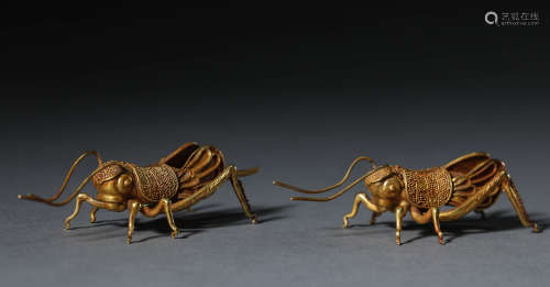 A pair of pure gold crickets