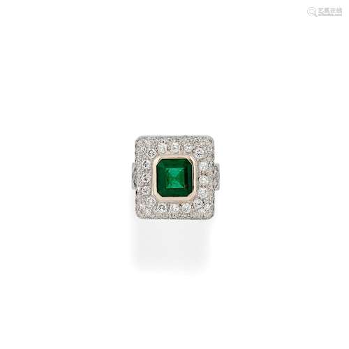 A 18K white gold emerald and diamond ring