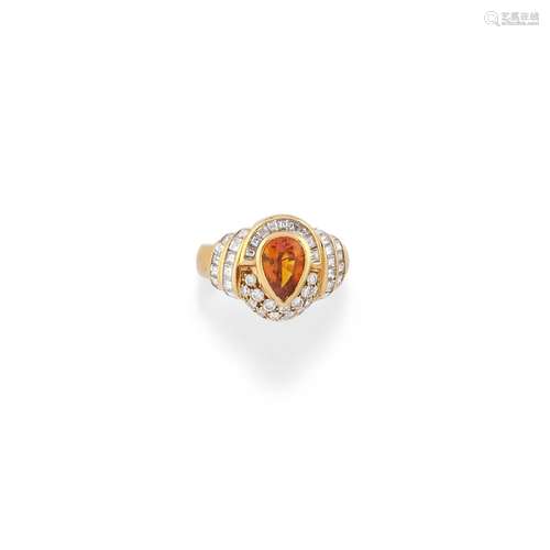 A 18K yellow gold, orange sapphire, dimaond ring