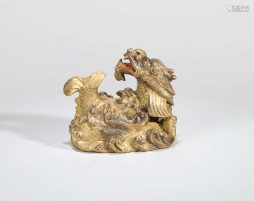 A GILT-BRONZE FISH TURNS INTO DRAGON PAPERWEIGHT