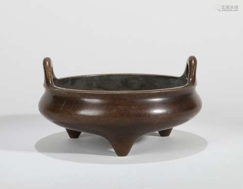 A BRONZE EARED TRIPOD CENSER