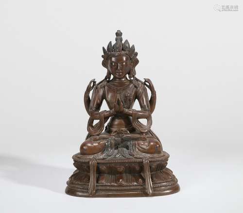 A BRONZE SEATED STATUE OF FOUR-ARMED AVALOKITESVARA