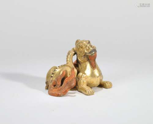 A GILT-BRONZE LION PAPERWEIGHT