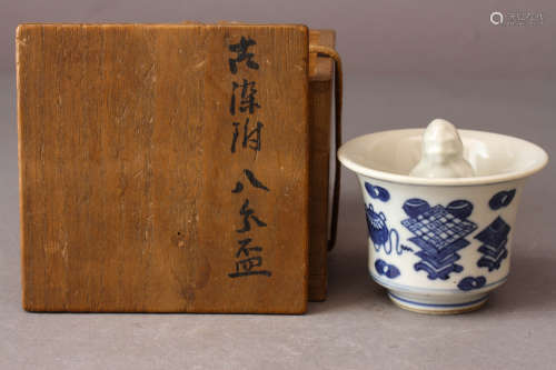 A BLUE AND WHITE TEA CUP WITH JAPANESE BOX