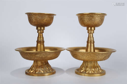 A Pair of Gilt Copper Offering Candlesticks.