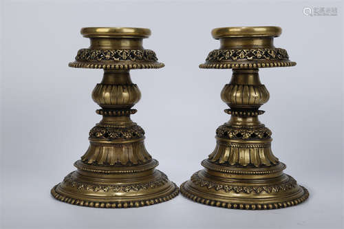 A Set of Gilt Copper Candlesticks.