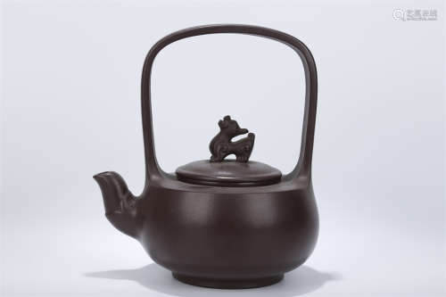A Purple Clay Teapot with Loop Handle.