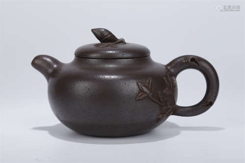 A Purple Clay Teapot with Flowers Design.