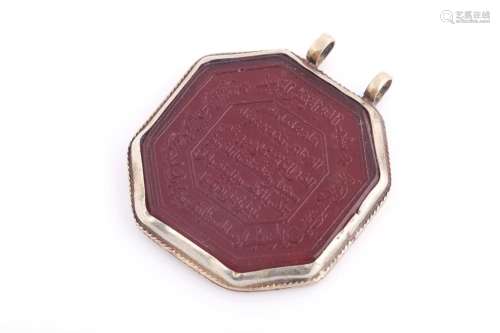 An Indo Persian red hardstone octagonal pendant in silver me...