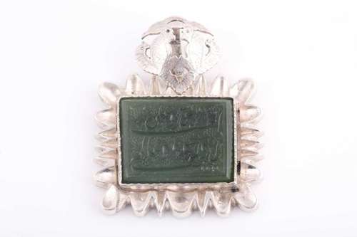 An Indo Persian white metal and jade pendant, the jaded engr...