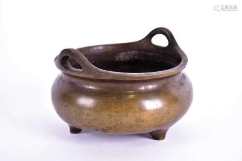 A Chinese bronze censer, Qing, 19th century, with loop handl...