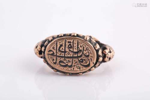 A Persian gold coloured metal gentleman's ring, in the ...
