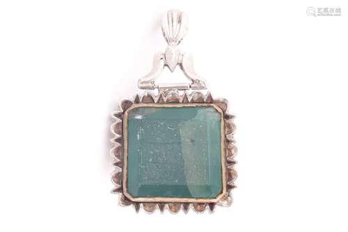 A large Indo Persian green stone pendant in white metal moun...