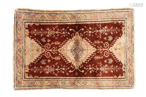 An antique Turkish rust-red ground silk mat with a central l...