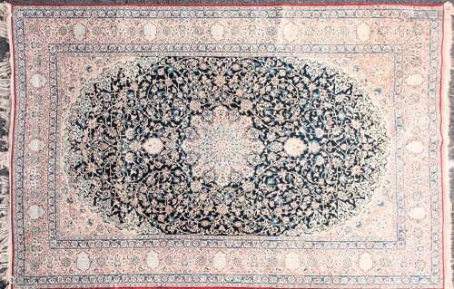 A 20th-century dark blue ground Kashan carpet with central m...