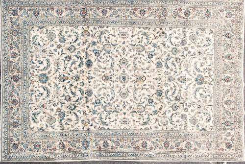 A 20th-century ivory ground Kashan carpet with a central fie...