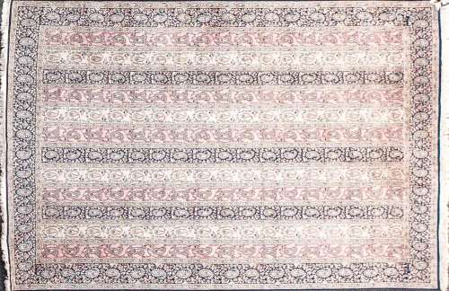 A Kashmiri silk carpet with striped boteh filled ground with...